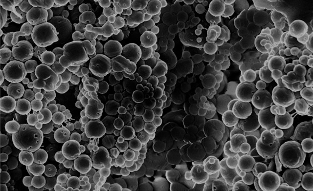 Scanning electron micrograph of clustered spherical nanoparticles.